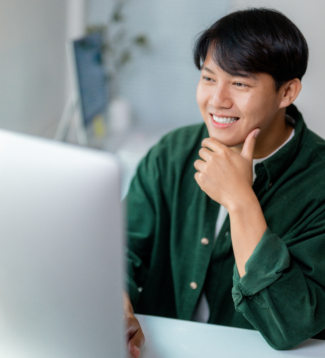 Student smiling while working on a computer